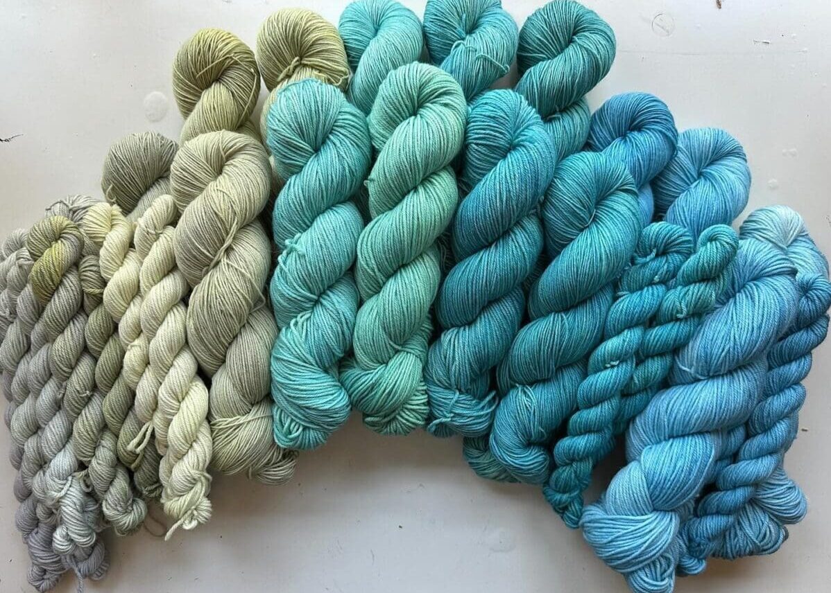 An array of Blue Thistle Fibers Naturally Dyed Green Yarns
