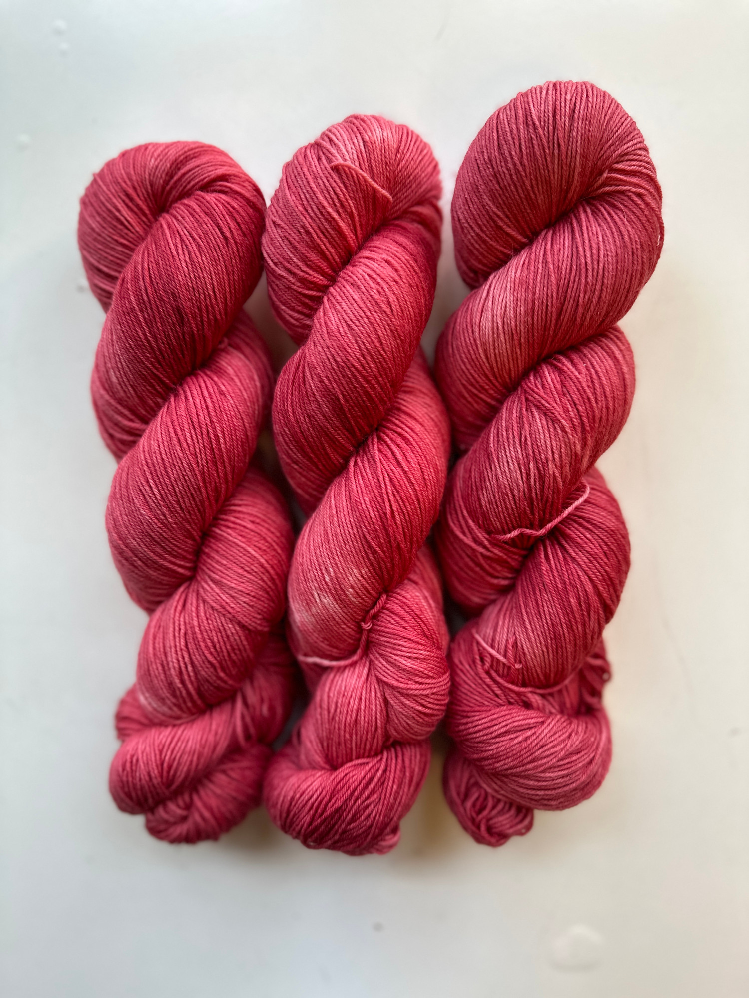 Maple Red variegated sock weight yarn skein, 75% merino / 25% recycled nylon, berry-leaning crimson